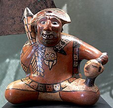 Representation of a warrior holding a trophy head.