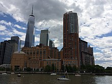 A southward view of Stuyvesant High School from Hudson River Park. The Hudson River is seen at right, and the skyscrapers of the new World Trade Center can be seen in the background.