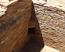 A color picture of a corner doorway in a large sandstone wall