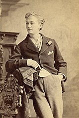 Boulton, leaning casually, with his hand in his pocket