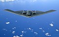 A B-2 Spirit stealth bomber flies over the Pacific Ocean