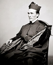 Photograph of Bernard Maguire seated