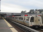 A BART train boarding passengers at the Daly City Station