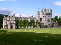 Balmoral Castle. The Royal Standard of Scotland flies over it.