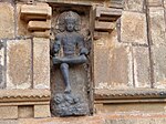 Dakshinamurti portrayed as the teacher of yoga, dance and sciences stepping over demon of ignorance.[48]