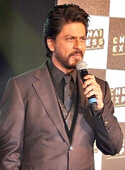 Shah Rukh Khan posing outside at a film festival