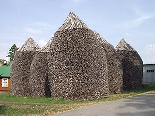 Firewood stacks at Pühtitsa Convent in Estonia are about 6 meters (20') high.