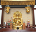 A Buddhist altar in Kawasaki, Japan showing a devotional mantra inscribed in Siddham to Shakyamuni Buddha with Japanese pronunciation guide