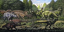 Painting of various dinosaurs in a green area