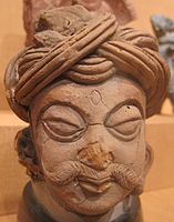 Terracotta head, wearing possibly an early form of pagri from the Gupta period.