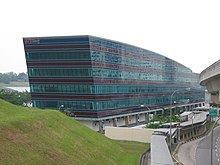View of a glass-covered blue building (the depot administrative building) along a road