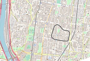Map showing modern street layout using Open Street Map graphics, overlaid with an outline of the old racetrack.