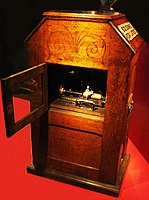 Rear view of a cabinet Kinetophone, showing its belt-driven wax cylinder phonograph