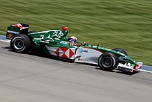 Webber driving his green Jaguar R5 at the 2004 United States Grand Prix at Indianapolis Motor Speedway