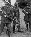 Three Polish resistance fighters pictured after liberating the "Gęsiówka" concentration camp – from left to right: Wojciech Omyła (code name “Wojtek"), Juliusz Bogdan Deczkowski (code name “Laudański") and Tadeusz Milewski (code name "Ćwik")