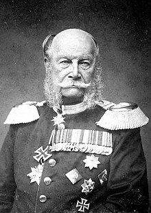 Photograph of an elderly William, a bald man with side whiskers