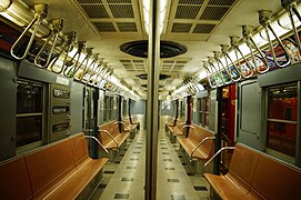 Older NYCTA R30 traincar has twin rows of pivoted grab handles