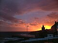 Sunset behind Porthleven clock tower and overlooking Mount's Bay