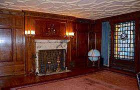 Corner of the boardroom, with fireplace and one of three large stained-glass windows