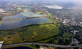 Image 6Seven reservoirs. View of four in Spelthorne with small lakes of lower elevation, from aggregate extraction, in the south of the borough to the right. Beyond three reservoirs in Elmbridge. The flattest areas of the far north of the county. Staines road and rail bridges span the Thames into Runnymede in the right of the photograph. (from Portal:Surrey/Selected pictures)