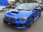 Subaru WRX S4 STI Sport, a high-performance variant of the Subaru WRX S4. This photo shows the front of the car, which is blue with a small "STI" emblem on the front grille.