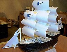 Model ship made with non-traditional materials: rolled-up tubes of paper, Express Mail labels, and duct tape.