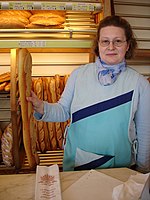 A modern protective tabard worn by a bakery worker