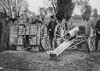 Black and white photo of a gun and its caisson in position.