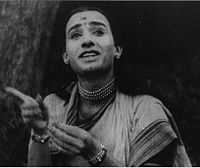 A black-and-white picture of a man posing as woman