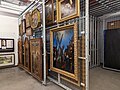 In museums, paintings, framed and unframed, are normally hung on sliding or fixed racking.