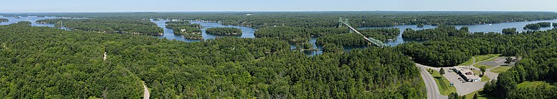 A view of some of the Thousand Islands, photographed in 2015 from atop the 1000 Islands Tower, facing northwest. The Thousand Islands are a North American archipelago of 1,864 islands that straddles the Canada–US border in the St. Lawrence River as it emerges from the northeast corner of Lake Ontario.