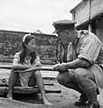 Image 10A liberated Chinese girl who had been forced in to sexual slavery by the Japanese military sits on a stretcher and speaks to a British military serviceman. (from Prostitution)
