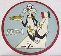 A This insignia was adopted in 1960. It features Sylvester the Cat wearing devices representing the three categories of naval personnel which make up the crew of an AVB: aviation, line, and Seabees. This ship's mission is represented by the runway, which emanates from two doors, symbolizing the bow doors of the ship. The colors on the doors are those of Italy where Alameda County is home ported. The runway markings represent the year (1957) in which this ship was designed AVB-1. Permission to use this copyrighted character was granted by Warner Brothers.
