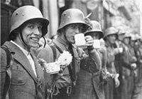 Volunteers of the Sudeten German Free Corps (German: Sudetendeutsches Freikorps) receiving refreshments from the local population in the city of Eger/Cheb)
