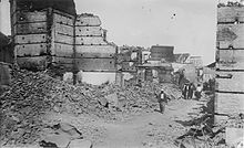 Destroyed cityscape with ruined buildings and rubble in the street