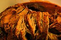 Cochinita Pibil, a fire pit-smoked pork dish, seasoned with achiote, spices and Seville orange.