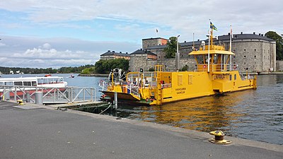 The Swedish ferry Vaxholmen with its destination, Vaxholm Castle, in the Stockholm Archipelago.