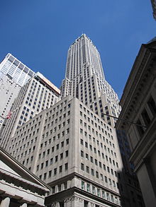 The building as seen from street level. 23 Wall Street is to the right, Federal Hall National Memorial is to the left, and 30 Wall Street is in the foreground.