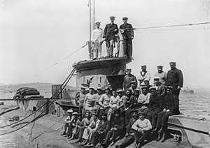 Crew of E14, seen after leaving the Dardanelles straits in 1915. Lt-Cmdr Boyle is standing at centre on the conning tower.