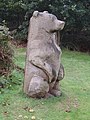 Wooden bear sculpture in the woods