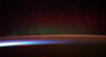 Image 77Earth's night-side upper atmosphere appearing from the bottom as bands of afterglow illuminating the troposphere in orange with silhouettes of clouds, and the stratosphere in white and blue. Next the mesosphere (pink area) extends to the orange and faintly green line of the lowest airglow, at about one hundred kilometers at the edge of space and the lower edge of the thermosphere (invisible). Continuing with green and red bands of aurorae stretching over several hundred kilometers. (from Earth)