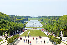 Image of a portion of the gardens of Versailles seen from in front of the palace's garden façade