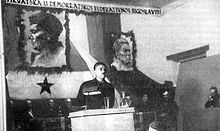 Andrija Hebrang speaking at a podium