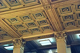 Elaborate ceiling panels and eagle-motif capitals in the ground-floor main banking room