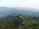 Pratapgad fort walls snaking along the edge of the hill