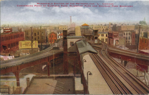 A painted view of a triple-railway interchange with a station of two island platforms past it; a single side platform is on the near side of the interchange, to the viewer's left.