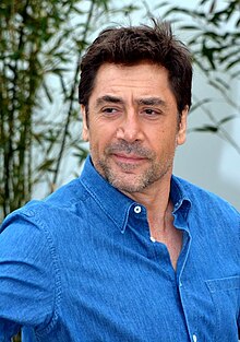 A photograph of Javier Bardem dressed in a blue shirt attending the 2018 Cannes Film Festival
