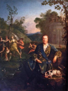A painted full-length portrait of Philippe de Vendôme, at the age of 69 with his dog and a open book in front of a landscape