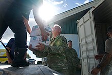 Photograph of the Hawaii National Guard delivering supporting material in advance of Hurricane Olivia