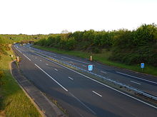 Vue légèrement plongeante des voies de l'autoroute A837, non loin de la jonction avec l'autoroute A10.